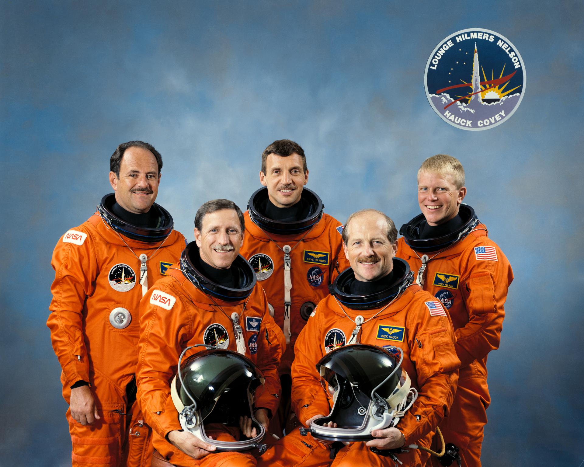 The five STS-26 astronauts wearing orange launch-and-entry suits. Back row: Lounge, Hilmers and Nelson. Front row: Covey and Hauck.